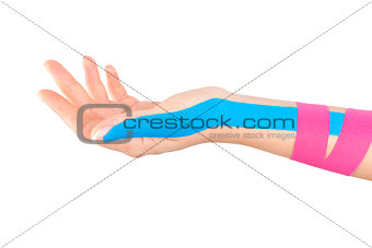Kinesio tape on female hand.