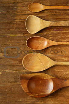 empty wooden spoons on an old grungy background