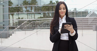 Stylish businesswoman using her tablet