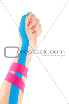 Kinesio tape on female hand.