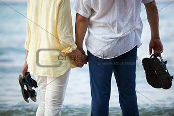 Couple holding hands at the seaside