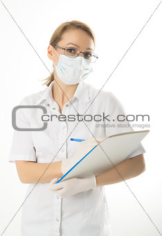 beautiful young female doctor in medical gown and rubber gloves holding a medical records. nurse making entries in medical records
