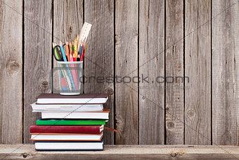 Wooden shelf with books and supplies