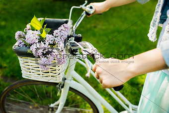 girl riding on a bicycle with flowers
