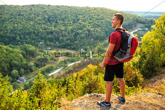 Men walk along the hill with backpack