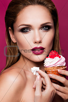 Beautiful fashion girl with cupcake