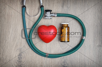 Stethoscope, pills and a heart 