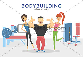 Happy bodybuilder with two women in the gym