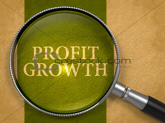 Profit Growth through Loupe on Old Paper.