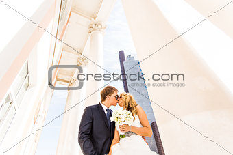 bride and groom on the background of glass building