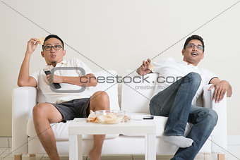 Men watching live sport match on tv at home