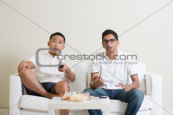 Men watching sport match on tv at home