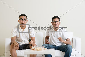 Men watching football game on tv together