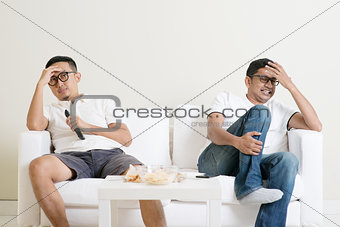Men watching football match together