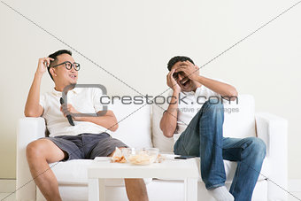 Men watching movie together