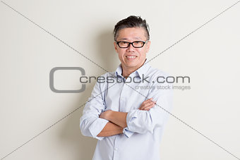 Portrait of mature Asian male arms crossed