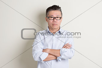 Portrait of mature Asian male people arms crossed