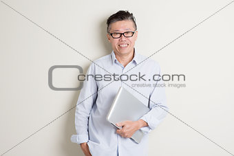 Mature Asian man and information technology concept