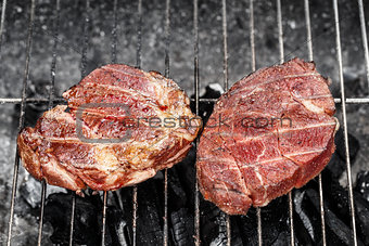 Beef steak cooking on a grill
