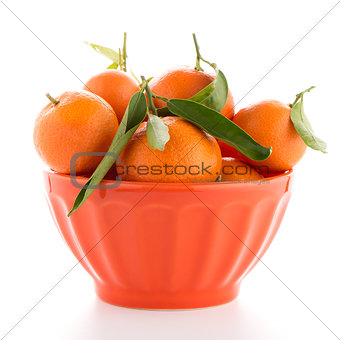 Tangerines on ceramic orange bowl 