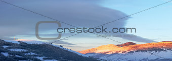 Sunrise Carpathian mountain winter panorama.