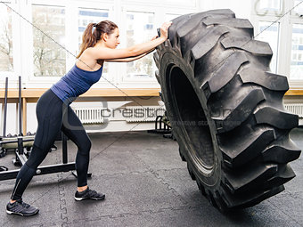Exercising with tire at crossfit gym