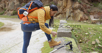 Female hiker tying her laces
