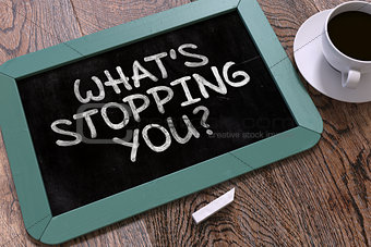 Whats Stopping You Handwritten by White Chalk on a Blackboard.