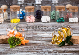 Alternative medicines with green leaves in glass containers