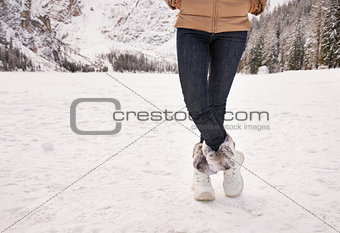 Closeup on legs of woman outdoors among snow-capped mountains