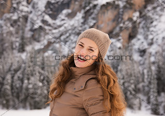 Portrait of happy woman outdoors among snow-capped mountains