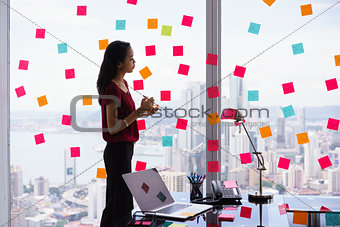 Secretary Organizing Tasks Writing Sticky Notes On Window