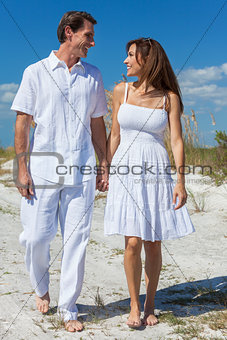 Middle Aged Couple Walking on An Empty Beach