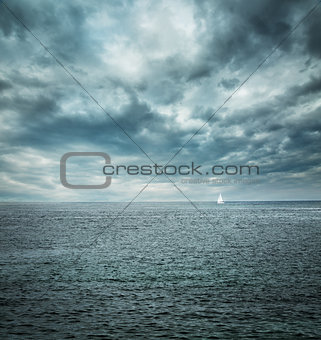 Sailing Boat at Stormy Sea. Dark Background.