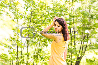 Portrait of young beautiful woman in spring blossom trees