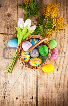 Easter eggs in wicker basket with copyspace