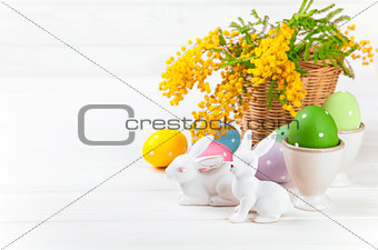 Easter eggs with rabbit and branch mimosa