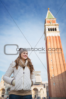 Woman standing in front of bell tower of St Mark's Basilica
