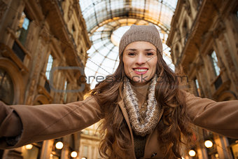 Happy woman taking selfie in Galleria Vittorio Emanuele II