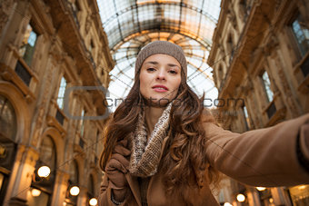 Glamour woman taking selfie in Galleria Vittorio Emanuele II