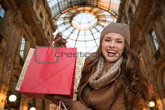 Woman in Galleria Vittorio Emanuele II showing shopping bags