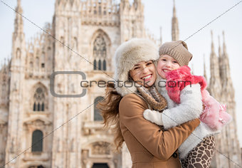 Portrait of happy mother and daughter near Duomo in Milan