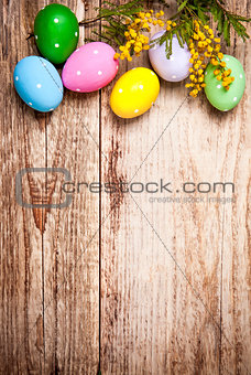 Easter eggs with bunch mimosa copyspace