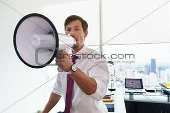 Business Man With Megaphone Doing Announcement In Office