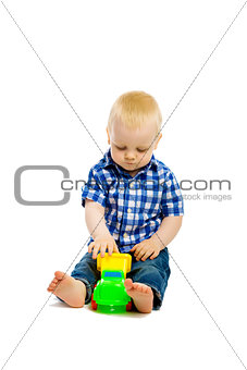 Baby boy playing with toys. isolated
