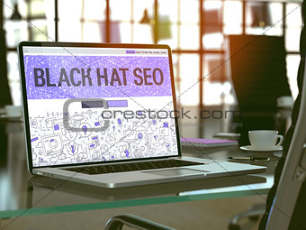 Black Hat SEO on Laptop in Modern Workplace Background.