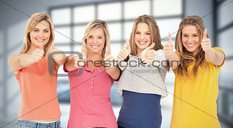 Composite image of girls sticking their thumbs up