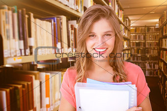 Composite image of smiling hipster holding notebook