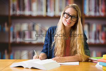 Composite image of student studying in the library