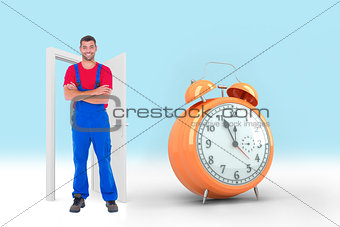 Composite image of handyman in overalls standing arms crossed over white backgound